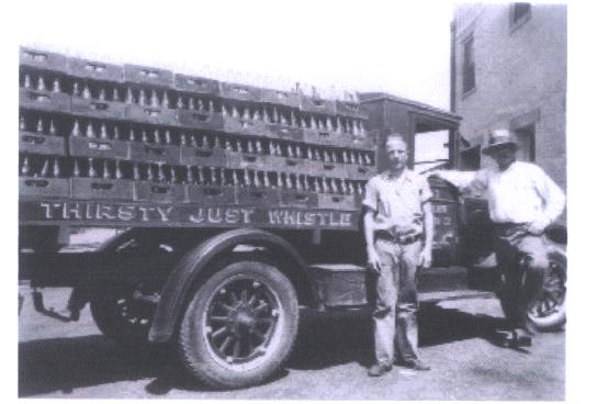 [B&W photo of soda delivery truck and the Condons]